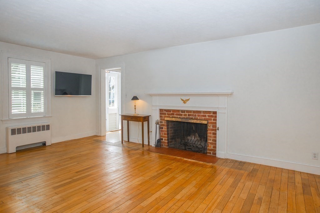 26 Hereford Road Marblehead, MA 01945 - Photo 12 of 23 a view of empty room with wooden floor and fireplace