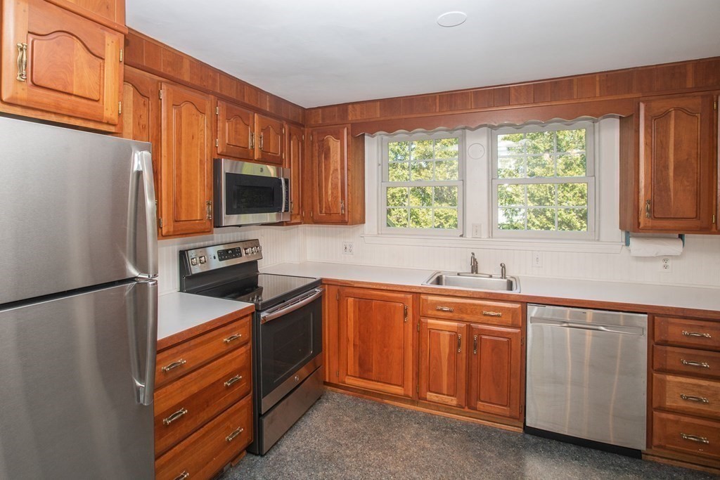 26 Hereford Road Marblehead, MA 01945 - Photo 9 of 23 a kitchen with a refrigerator stove and microwave