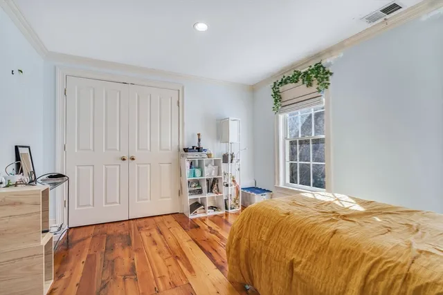 a bedroom with a large bed and a window