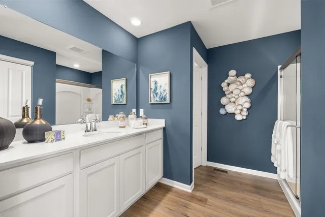 a bathroom with a double vanity sink and mirror