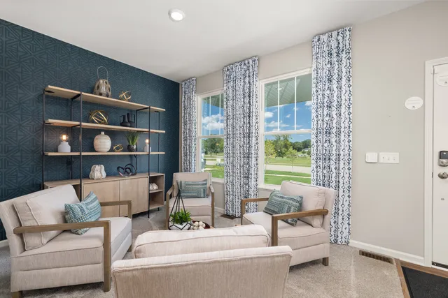 a living room with furniture and a book shelf