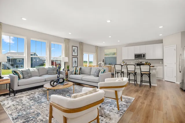 a living room with furniture and kitchen view