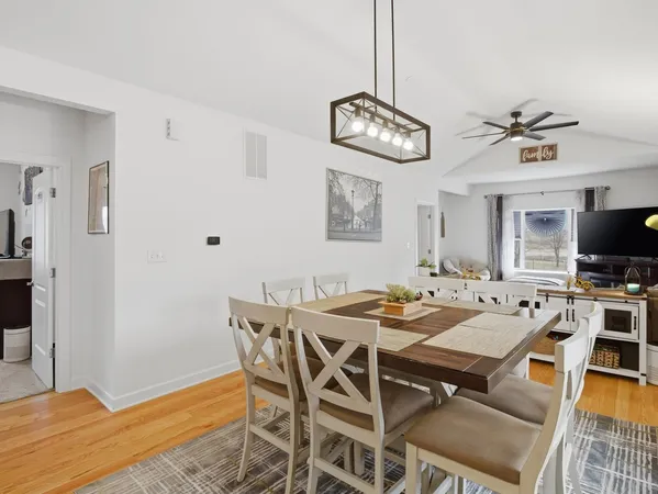 a kitchen with kitchen island granite countertop a sink cabinets and stainless steel appliances