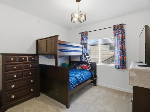 a bedroom with a bed and a chandelier