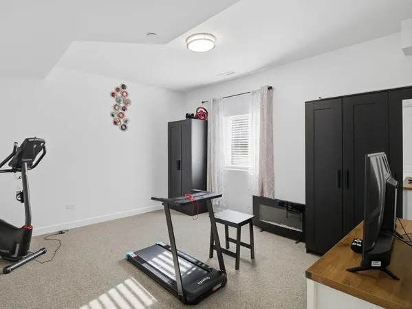 a view of a workspace with furniture and a flat screen tv