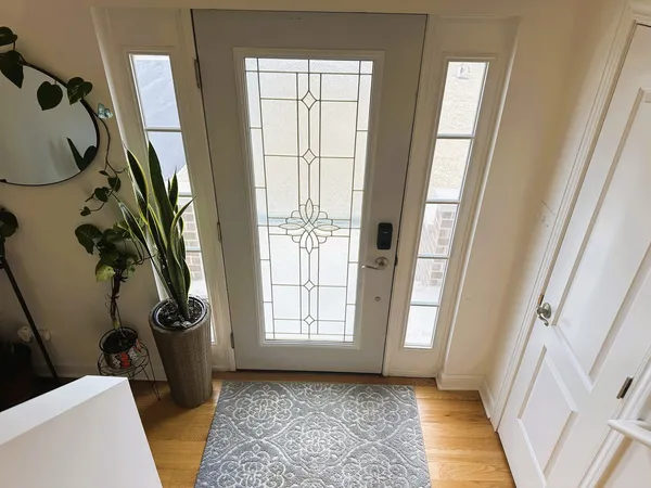 a view of a hallway with closet and front door