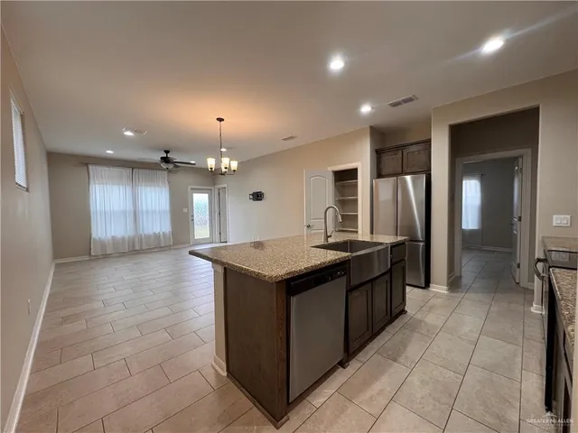 a kitchen with stainless steel appliances granite countertop a stove and a refrigerator