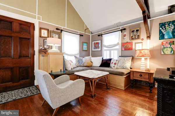 a living room with furniture fireplace and a large window