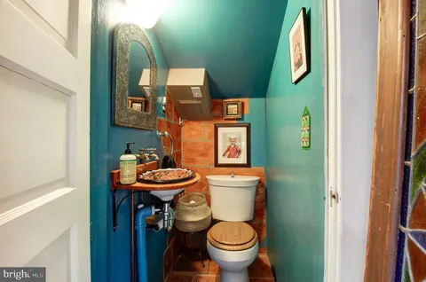 a bathroom with a toilet sink and mirror