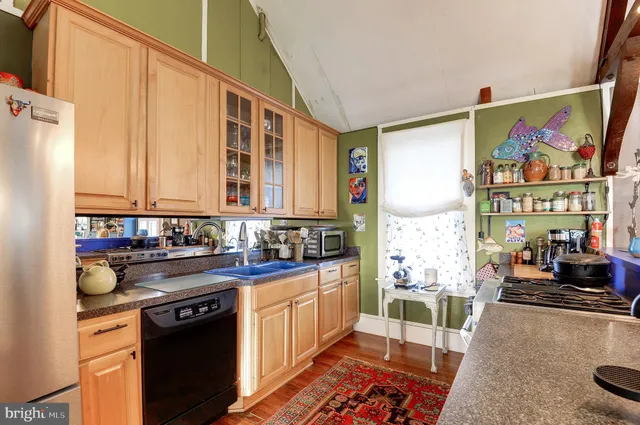 a kitchen with stainless steel appliances a stove a sink and a refrigerator