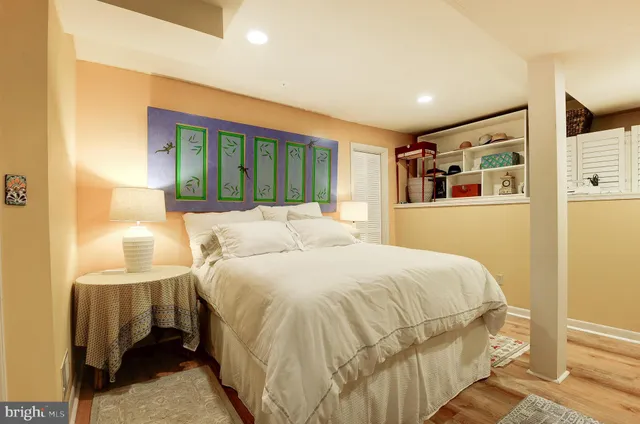 a large bedroom with a bed and a flat screen tv