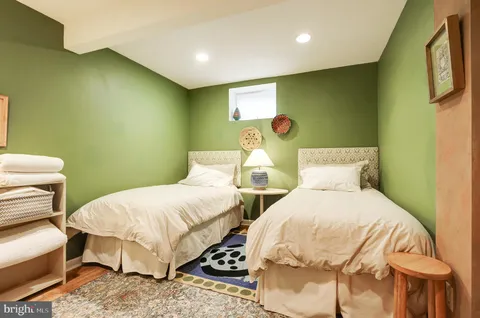 a bedroom with a bed and a chair