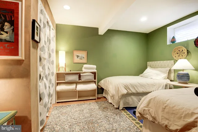 a bedroom with two beds and painted walls