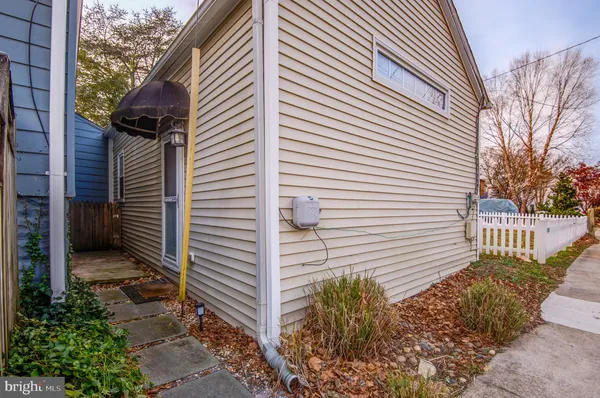 a view of a kitchen with a sink and wooden floor