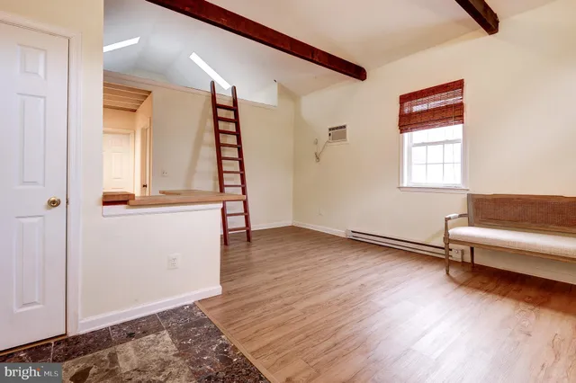 a view of a kitchen with a sink and wooden floor