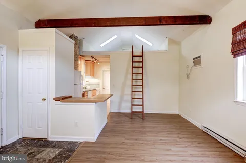 a view of a kitchen with wooden floor and a sink