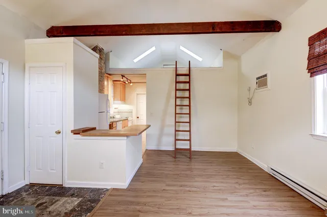 a view of a kitchen with wooden floor and a sink
