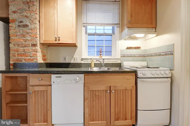 a kitchen with stainless steel appliances granite countertop a sink and cabinets