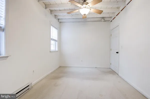 a view of an empty room with windows