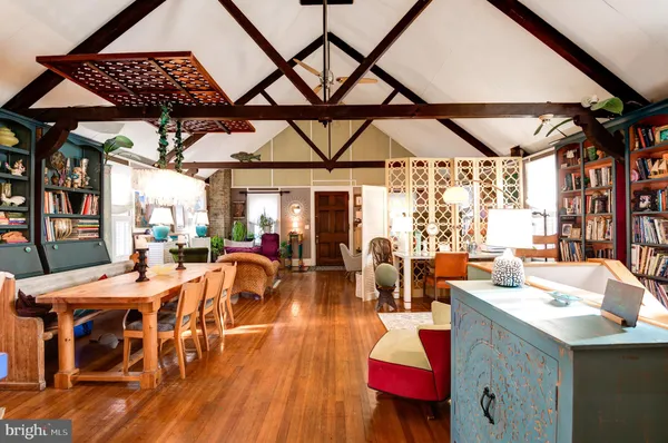 a living room with lots of furniture and a wooden floor