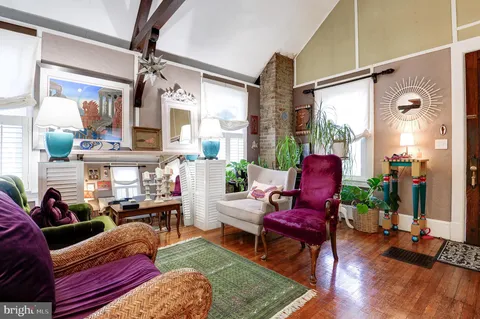 a living room with furniture fireplace and a large window