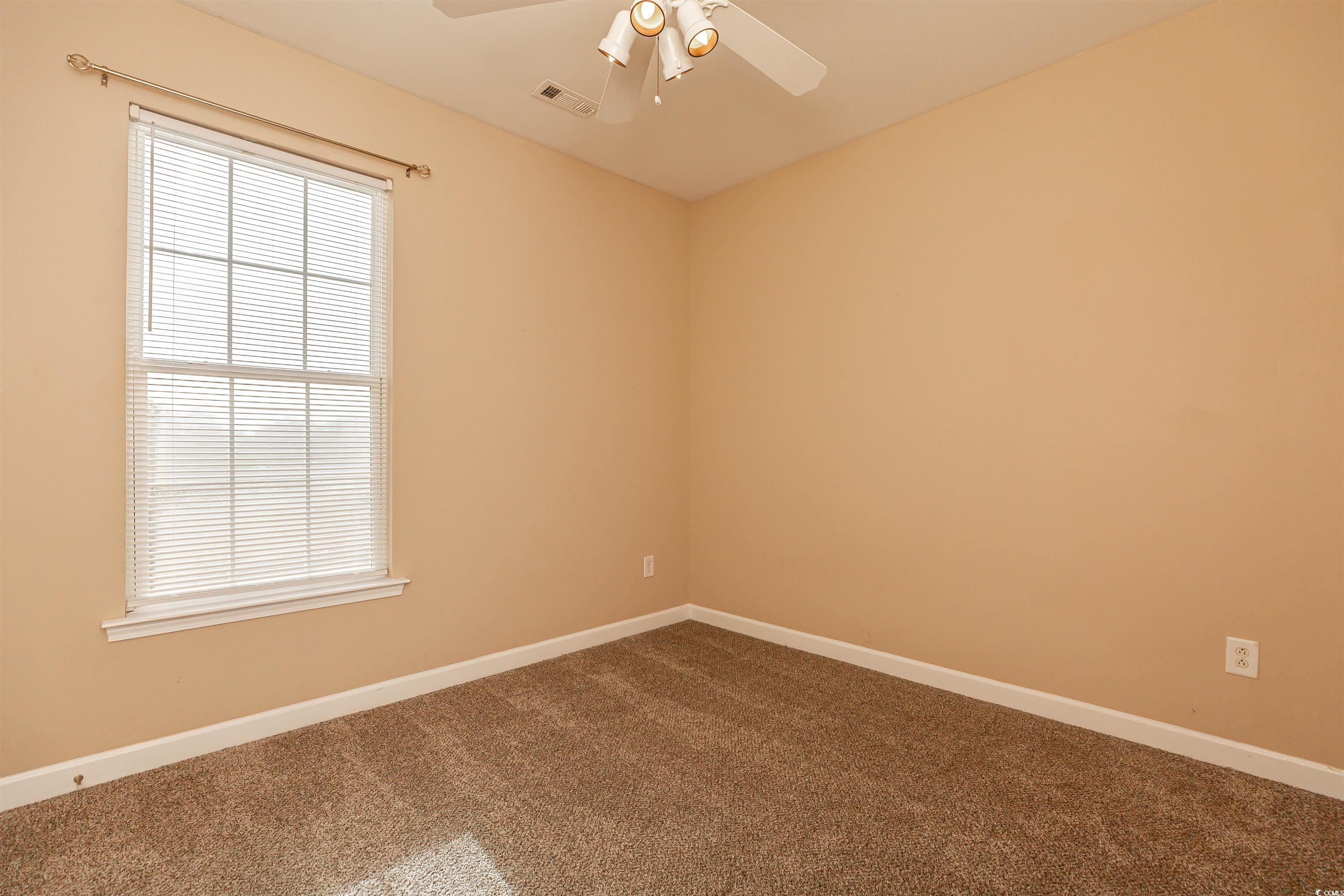 2954 Yancey Way, Unit B Myrtle Beach, SC 29577 - Photo 15 of 24 Spare room with baseboards, a ceiling fan, dark co