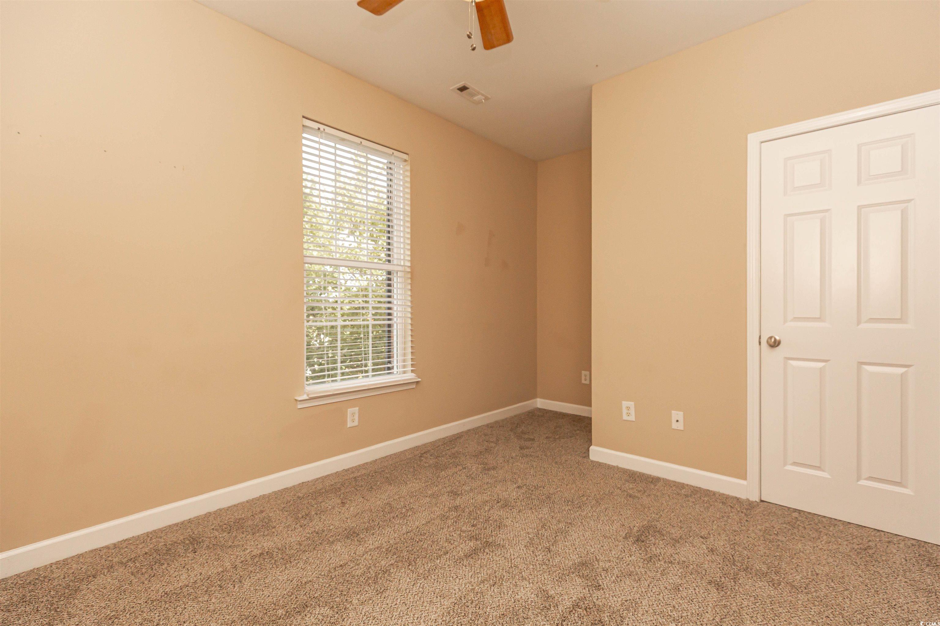 2954 Yancey Way, Unit B Myrtle Beach, SC 29577 - Photo 22 of 24 Carpeted empty room with baseboards, a ceiling fan
