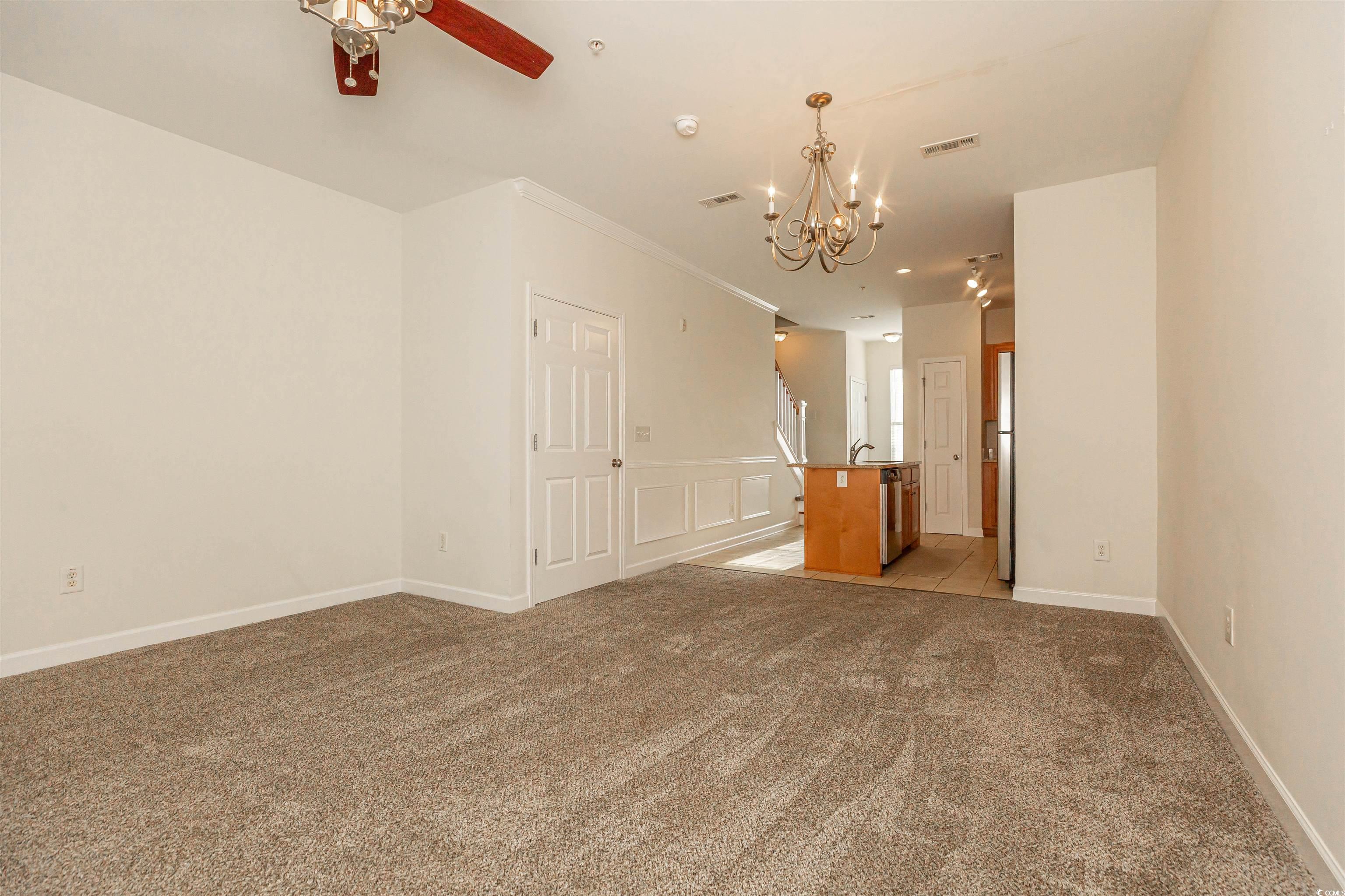 2954 Yancey Way, Unit B Myrtle Beach, SC 29577 - Photo 7 of 24 Empty room with light carpet, ornamental molding,