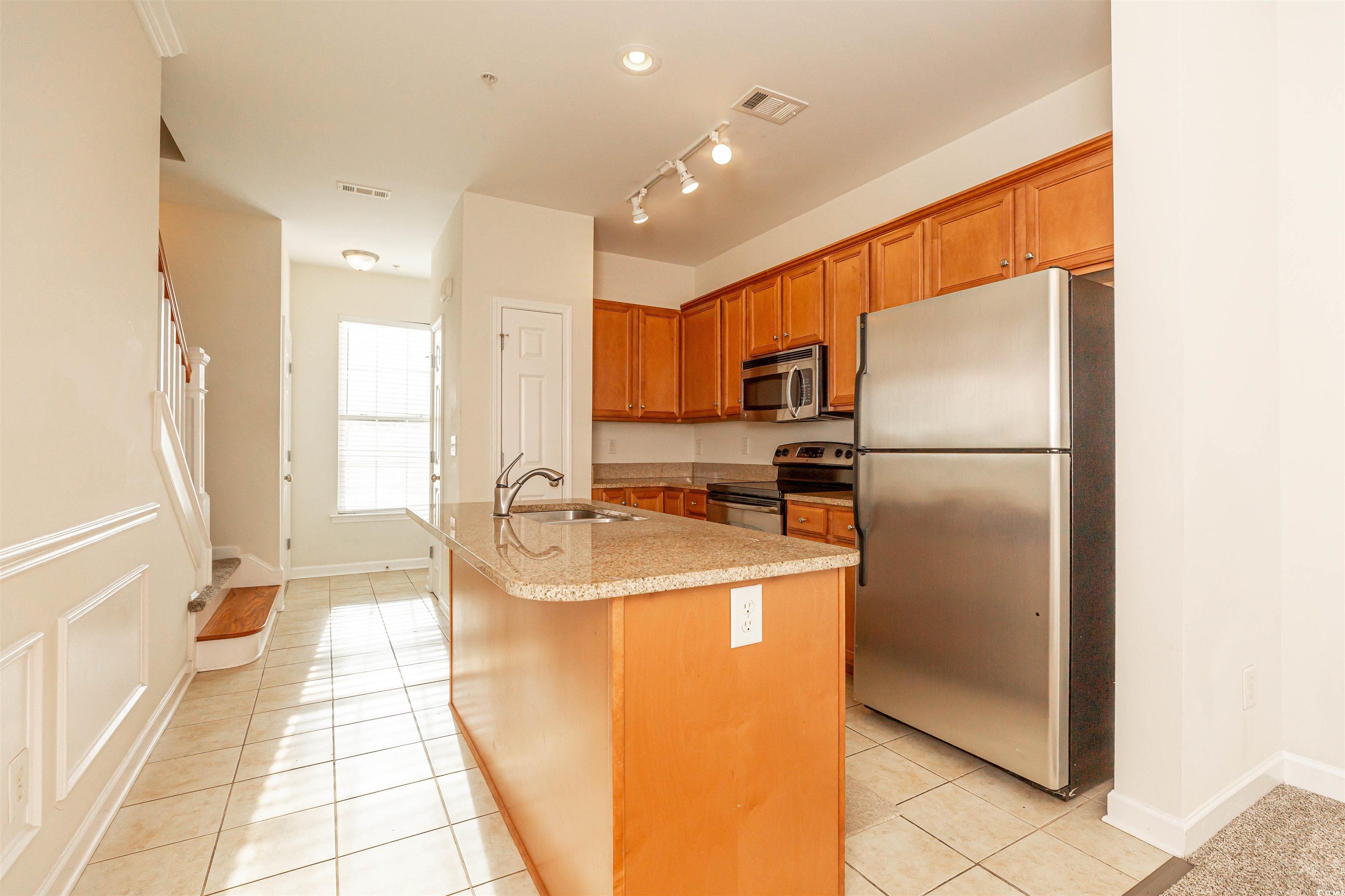 2954 Yancey Way, Unit B Myrtle Beach, SC 29577 - Photo 9 of 24 Kitchen featuring a sink, brown cabinets, light ti