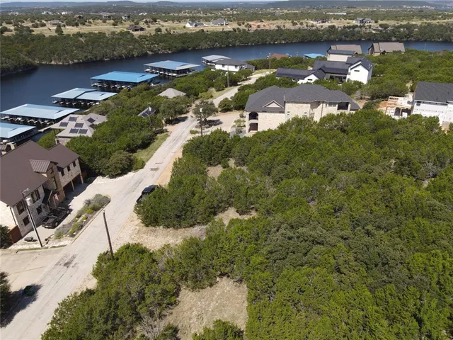 an aerial view of residential houses with outdoor space and river