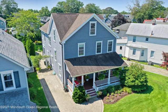 a aerial view of a house with a yard table and chairs