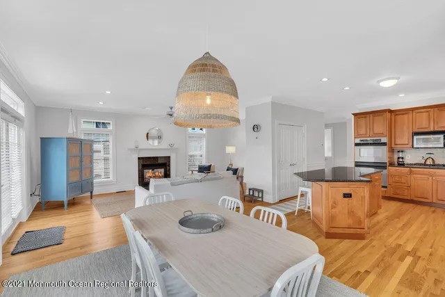 a living room with furniture a table and kitchen view