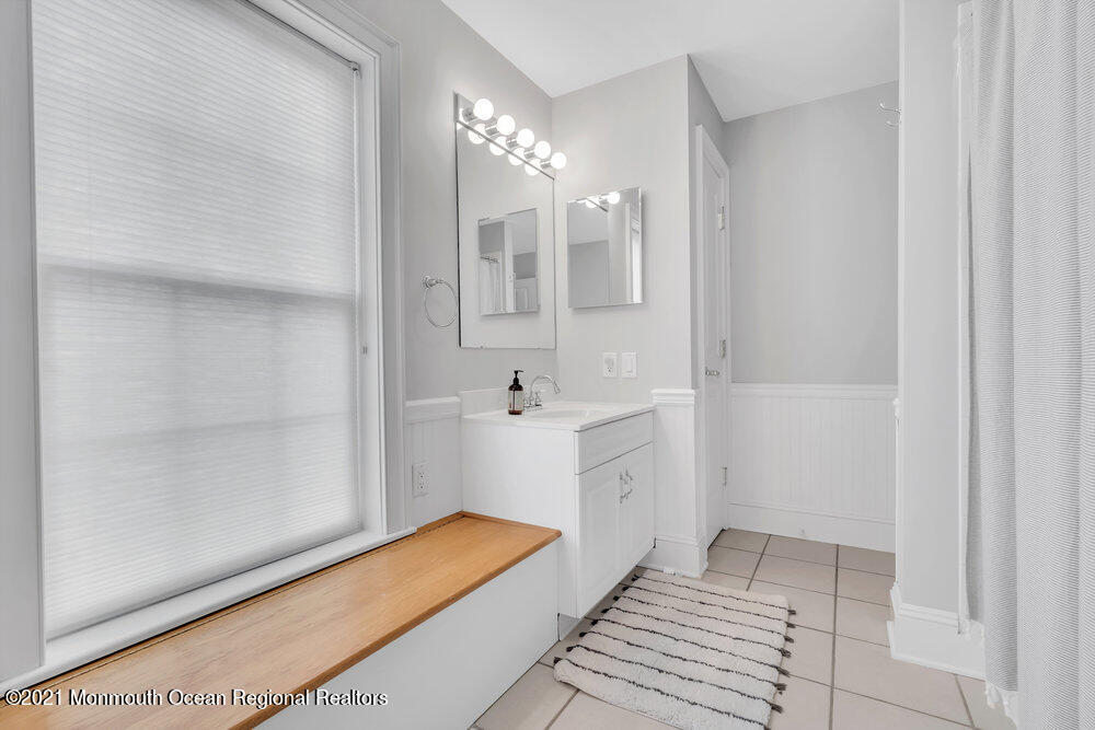 507 Washington Avenue Spring Lake, NJ 07762 - Photo 17 of 29 a bathroom with a sink a mirror and a shower