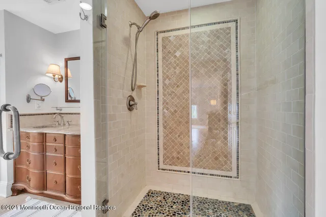 a bathroom with a glass shower door and a window