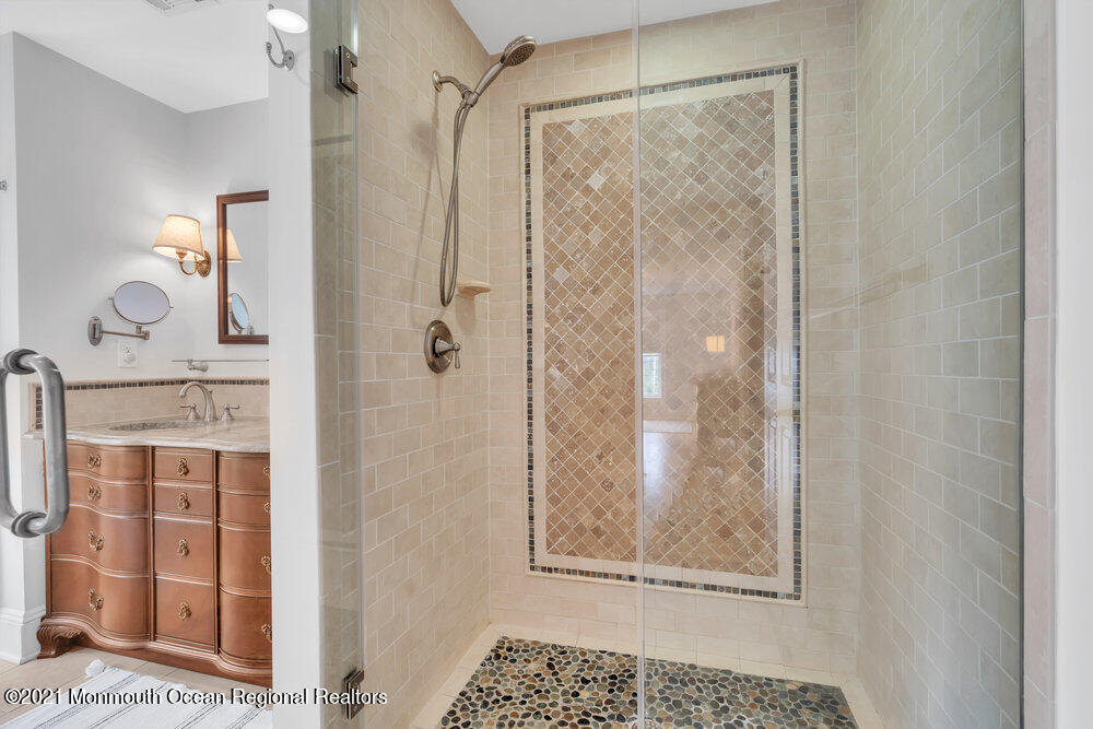 507 Washington Avenue Spring Lake, NJ 07762 - Photo 23 of 29 a bathroom with a glass shower door and a window