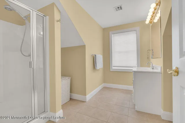 a bathroom with a shower and a sink