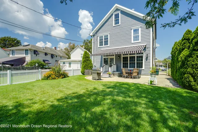 a front view of a house with swimming pool having outdoor seating