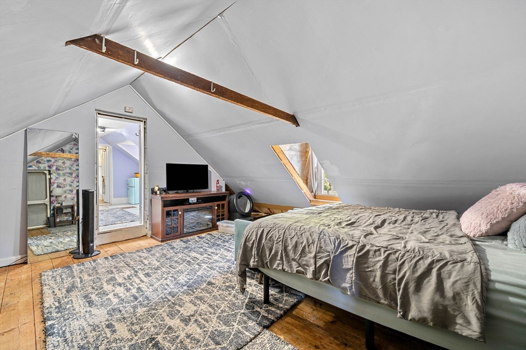 600 Main Street Ashby, MA 01431 - Photo 32 of 40 a bedroom with a bed and a flat screen tv