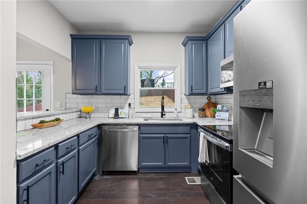 731 Dill Avenue Southwest Atlanta, GA 30310 - Photo 15 of 25 a kitchen with a sink stove and cabinets