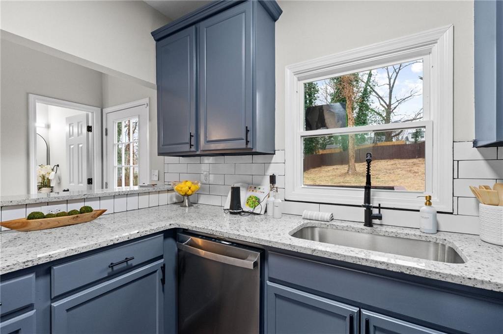 731 Dill Avenue Southwest Atlanta, GA 30310 - Photo 16 of 25 a kitchen with stainless steel appliances granite countertop a sink and a window