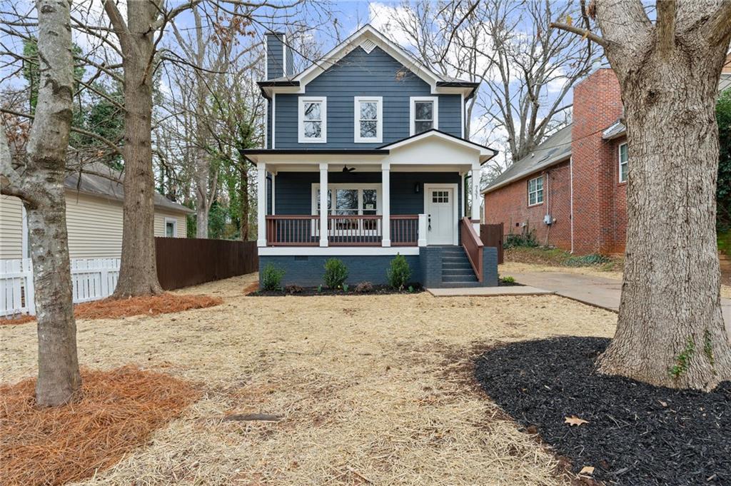 731 Dill Avenue Southwest Atlanta, GA 30310 - Photo 2 of 25 a front view of a house with a yard and garage