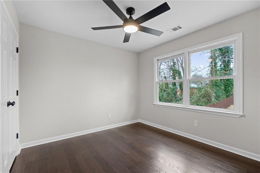 731 Dill Avenue Southwest Atlanta, GA 30310 - Photo 24 of 25 an empty room with wooden floor and windows