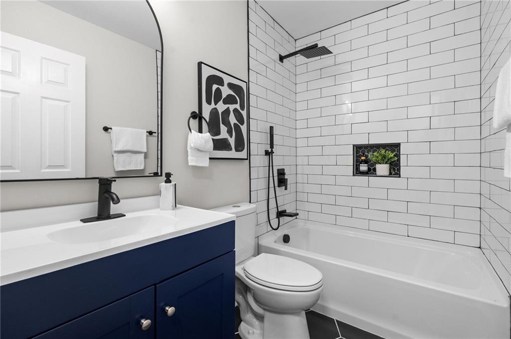 731 Dill Avenue Southwest Atlanta, GA 30310 - Photo 25 of 25 a bathroom with a sink a toilet and shower