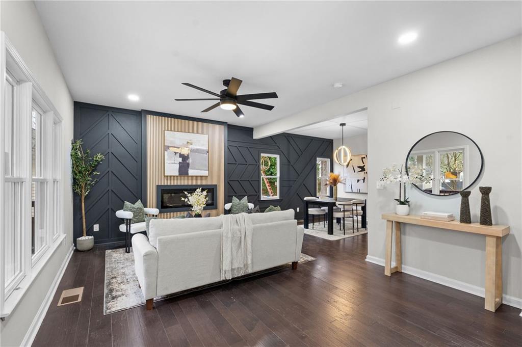 731 Dill Avenue Southwest Atlanta, GA 30310 - Photo 8 of 25 a living room with furniture a large window and wooden floor