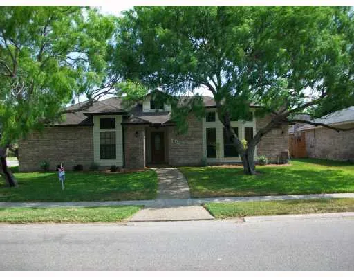 a front view of a house with a yard and a garage