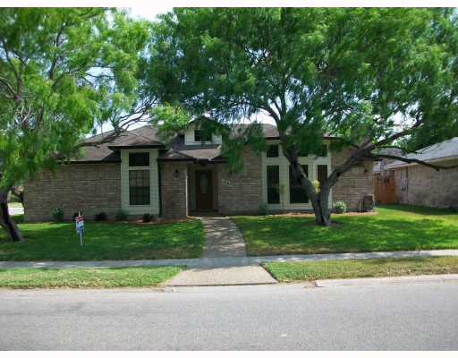 a front view of a house with a yard and a garage