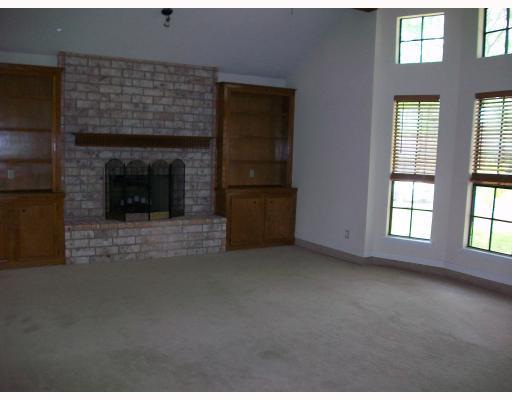 4702 Megal Drive Corpus Christi, TX 78413 - Photo 2 of 6 an empty room with windows and fireplace
