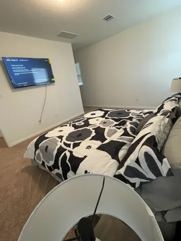 a view of a bedroom with a bed