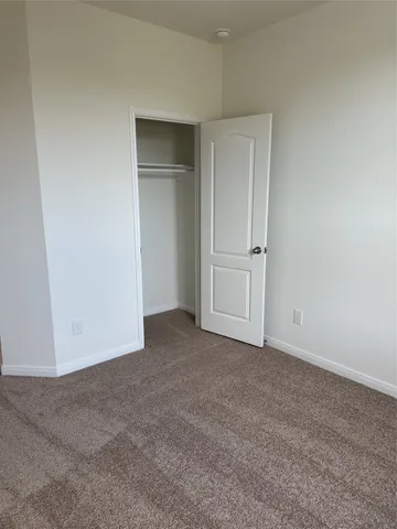 a view of an empty room and closet area