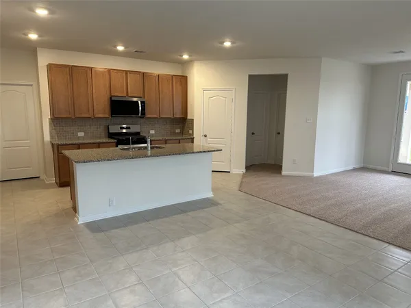 a kitchen with stainless steel appliances a refrigerator sink stove microwave and cabinets